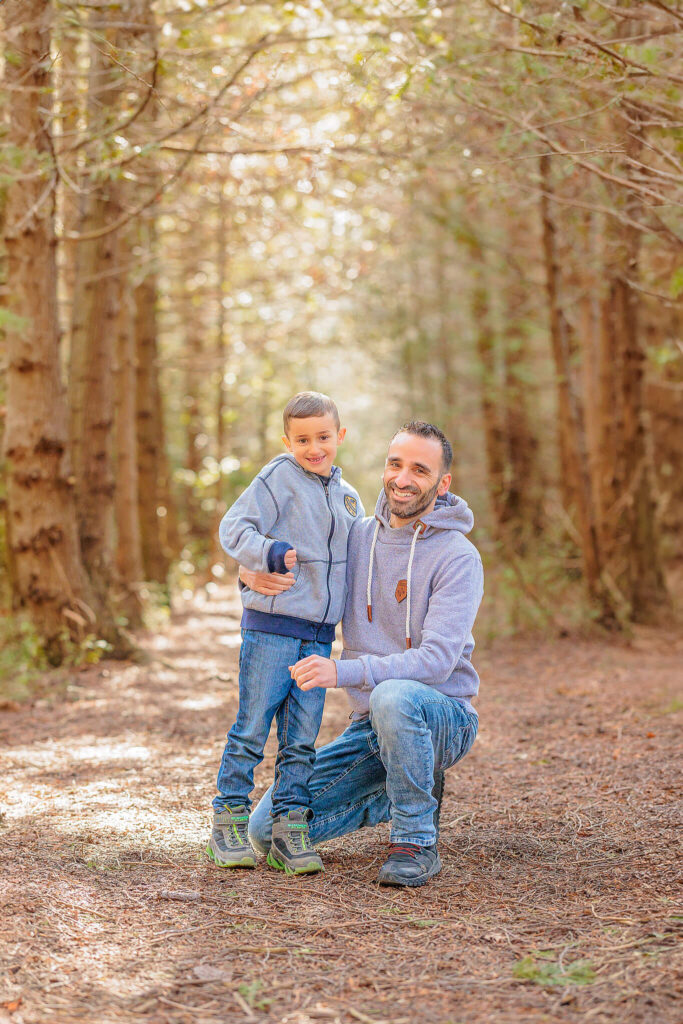 Father and son together, smiling at the camera