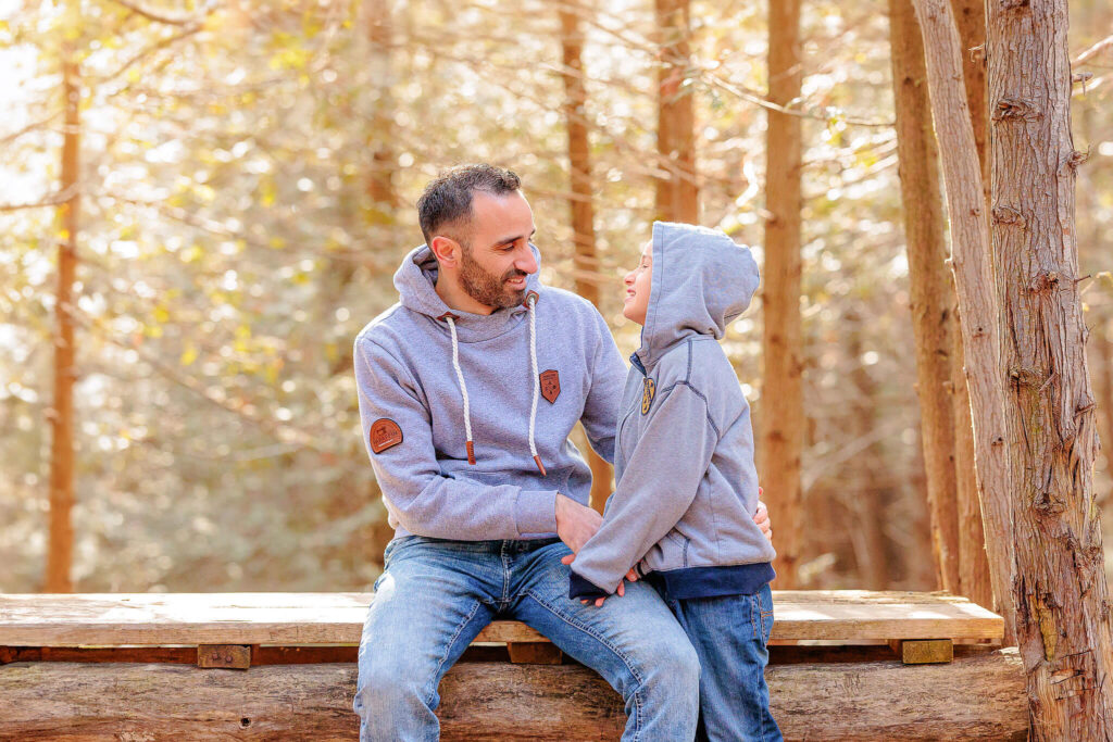 A father and son laughing and playing with each other during a photo session