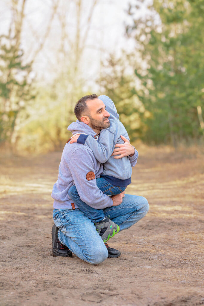 A father and son hugging during a photo session.